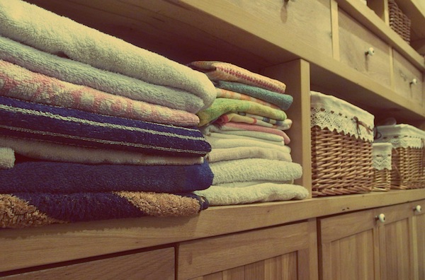folded towels stacked in cabinet