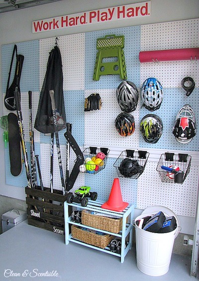 a pegboard hangs in a garage to organize sports gear