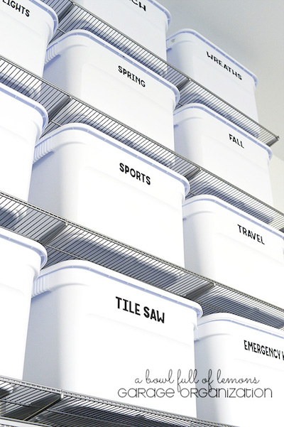 a tower of organized and labeled boxes in a garage shelf