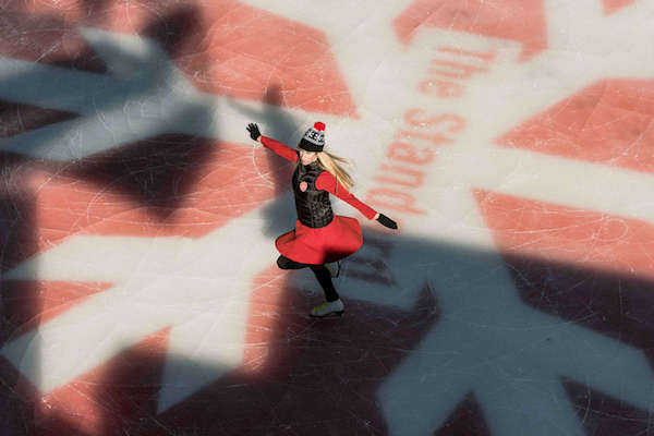 a woman skates on the ice skating rink at the standard hotel