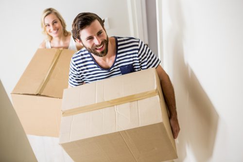 carrying boxes moving out of apartment