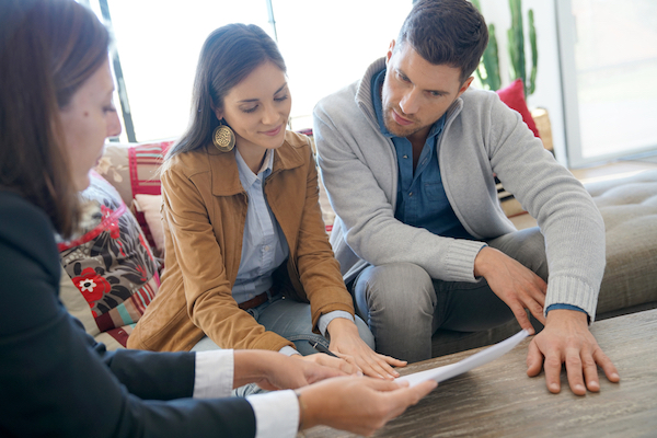 man and woman signing home contract