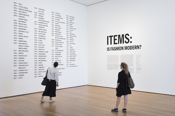 two women peruse an exhibit at moMa on fashion