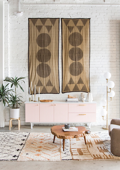 oversized tapestry art hangs from a bohemian room