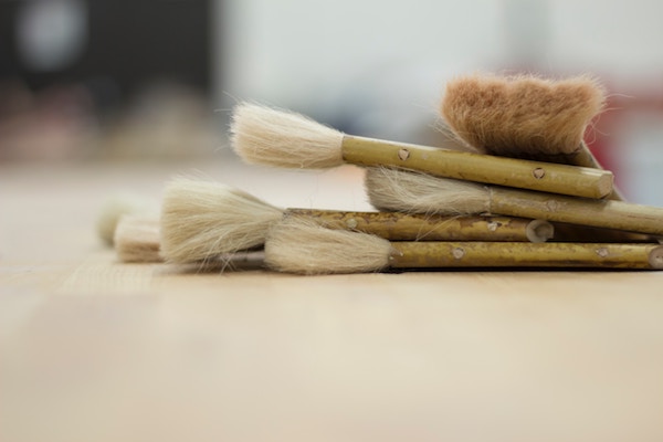 a pile of clean brushes lie stacked together on a table