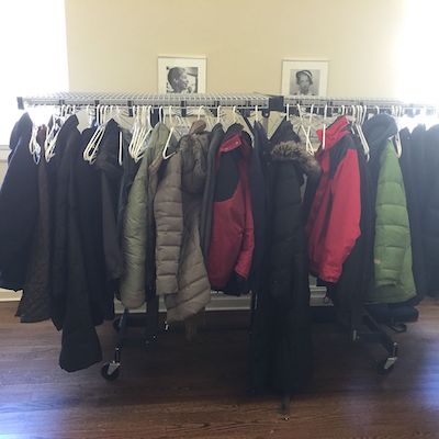 similar winter coats hung together on rack