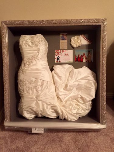 a wedding dress stored in a shadow box