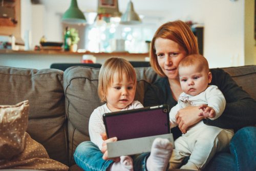 a mom with her two kids on a couch