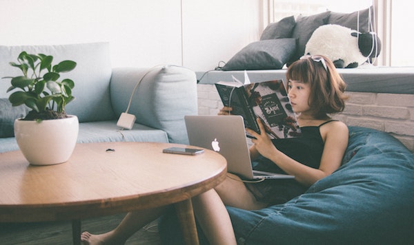 woman reading while sitting in bean bag chair