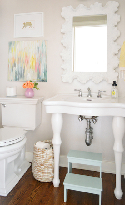 bathroom with artwork and mirror