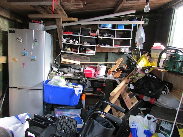 cluttered garage with messy shelves