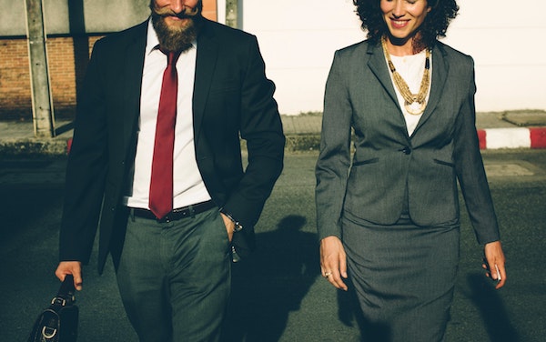 professional man and woman wearing suits
