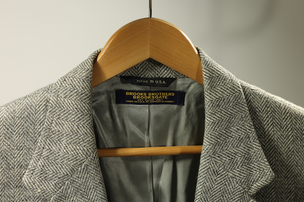 brooks brothers herringbone suit on wooden hanger