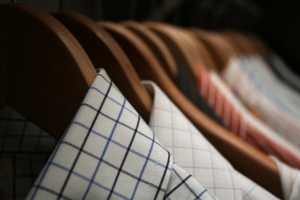 dress shirts hanging on wooden hangers