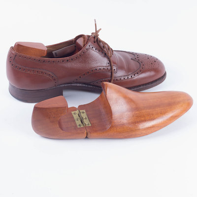 cedar shoe tree with brown leather men's shoe