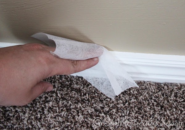 dusting baseboards with a dryer sheet