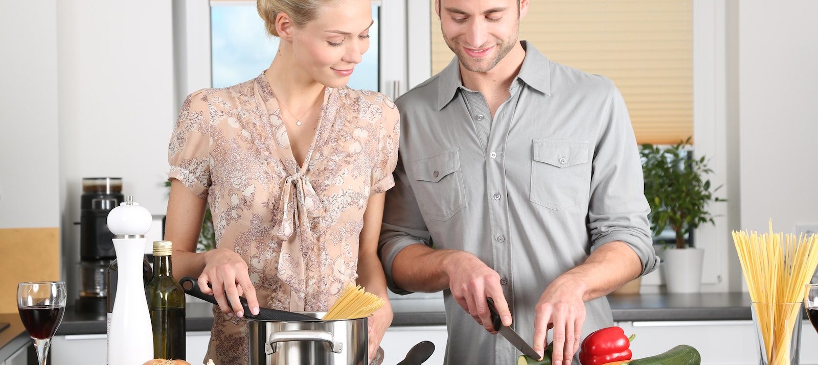 male and female couple cooking in the kitchen