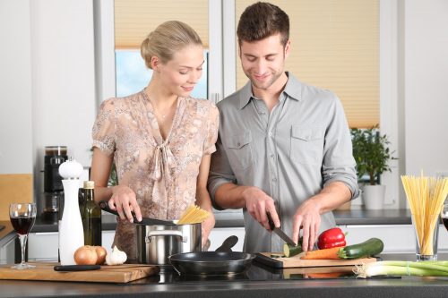 male and female couple cooking in the kitchen