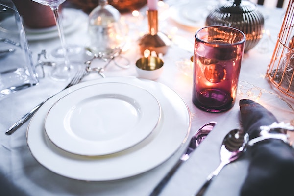 white plates place setting at a dinner party