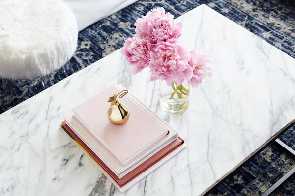 marble coffee table with flowers and small books