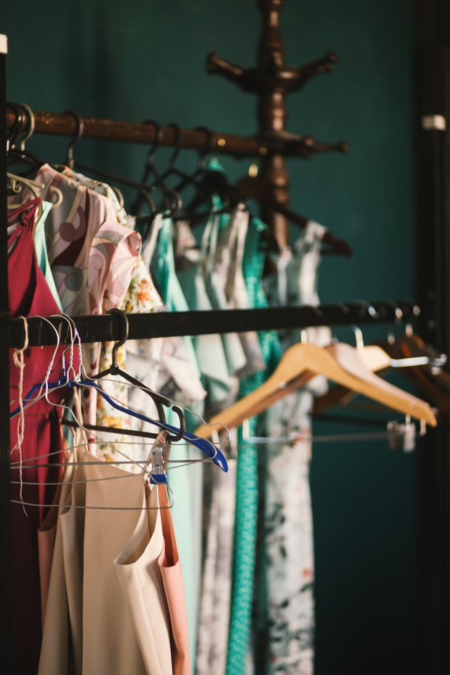 a bunch of clothes hanging by the hanger 