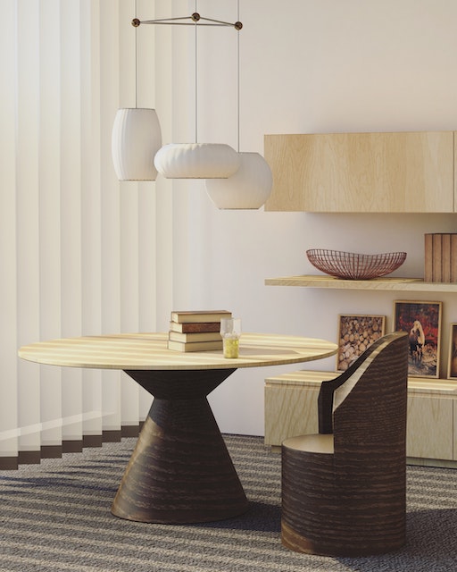 a white round table with white hanging light fixtures