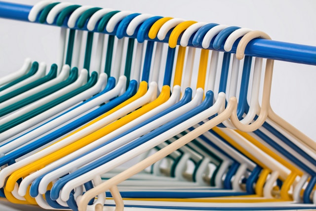 bright yellow and blue plastic hangers