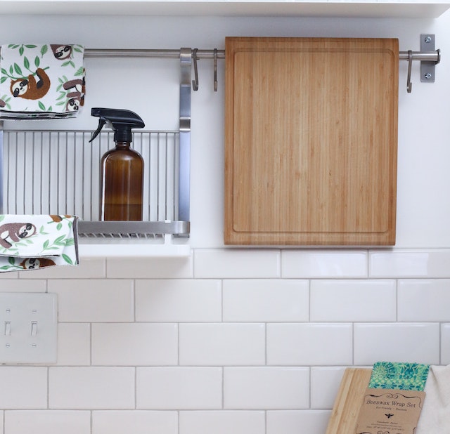 a kitchen counter wall with hanging caddy 