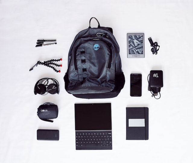 a backpack, a computer and a notebook 