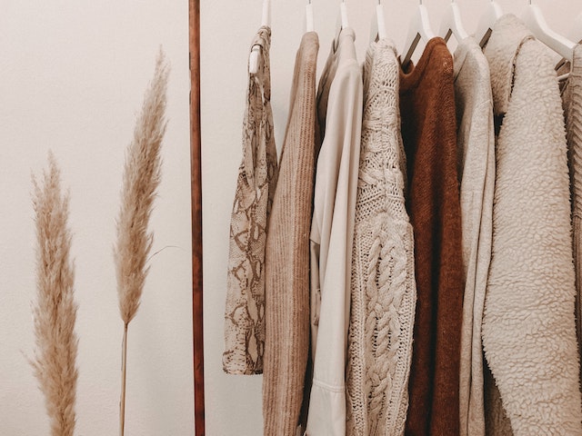 sweaters hanging in a closet