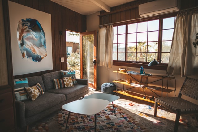 living room with an area rug and sunlight pouring in