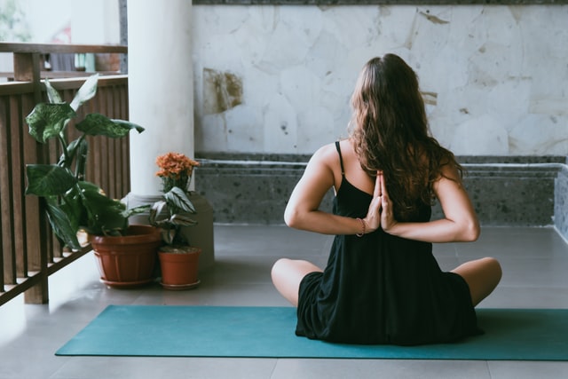 a girl in a yoga pose on a mat