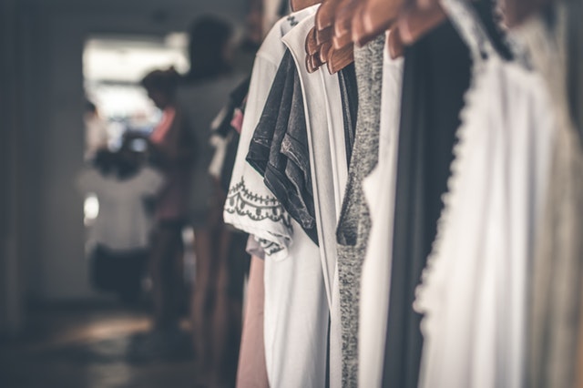 A closet with clothes hanging in it