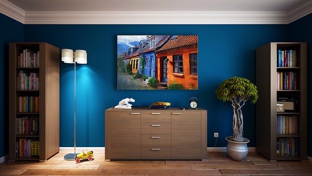 an accent teal wall decorated with a painting