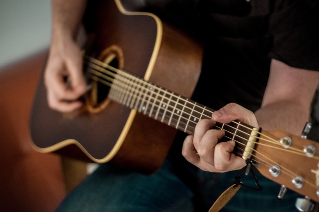 A person strumming a guitar