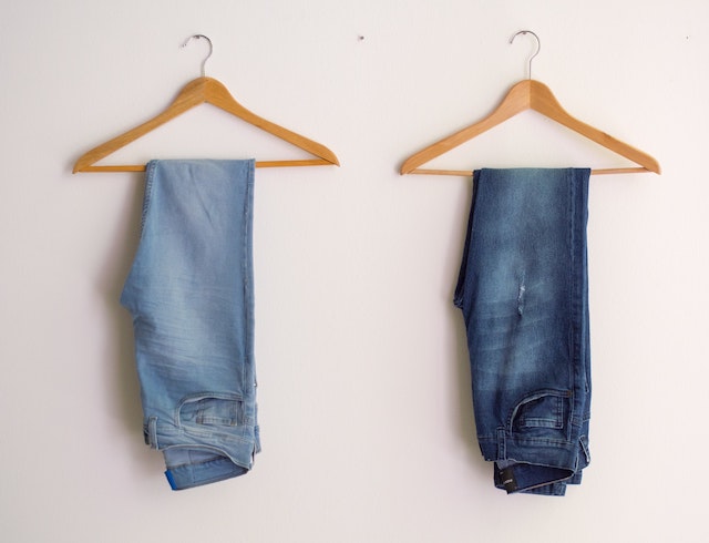 Two pairs of jeans on a hanger
