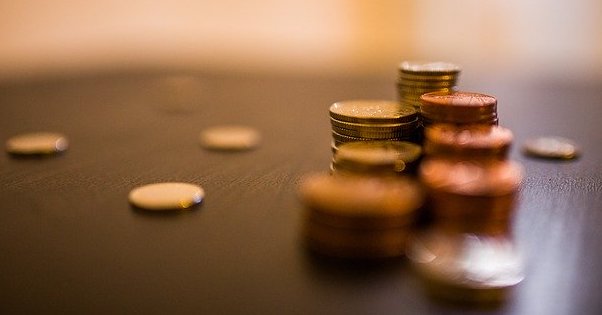 Pennies lined up on a wooden table