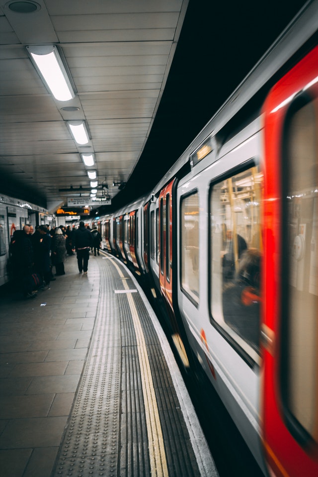 People standing at an underground train station 