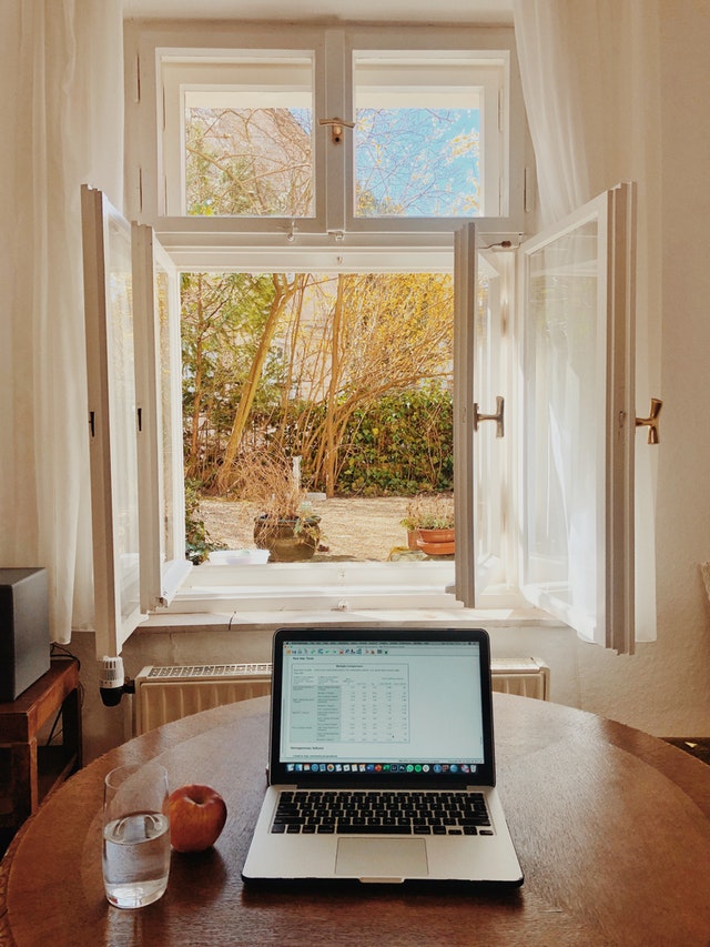 A work desk by the window with natural light and fresh air