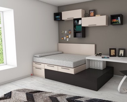 A bed with little shelves on a side-wall