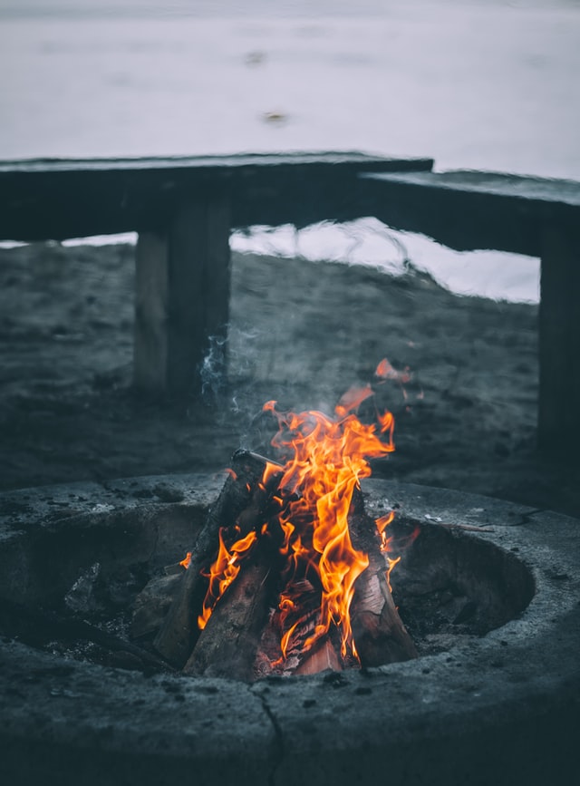 A fire burning inside a concrete fire pit