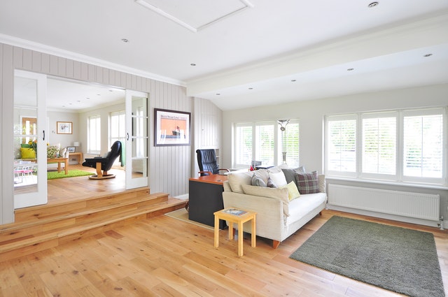 A spacious room covered with clean oak hardwood floors