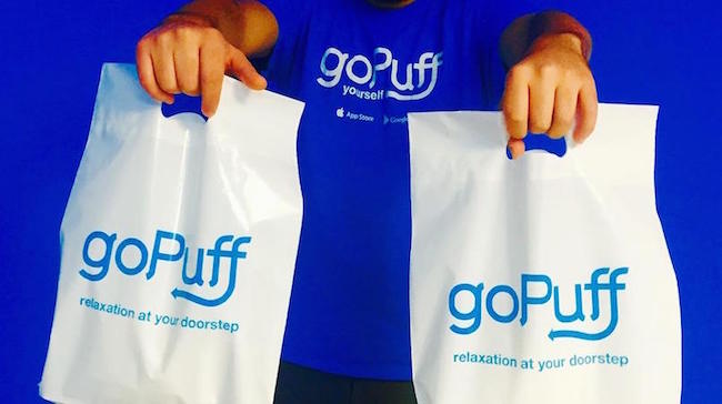 A person holding bags of gopuff