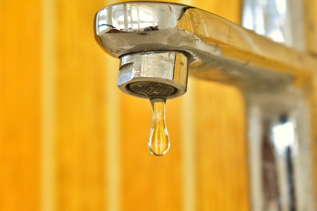 A water droplet coming out a tap. 