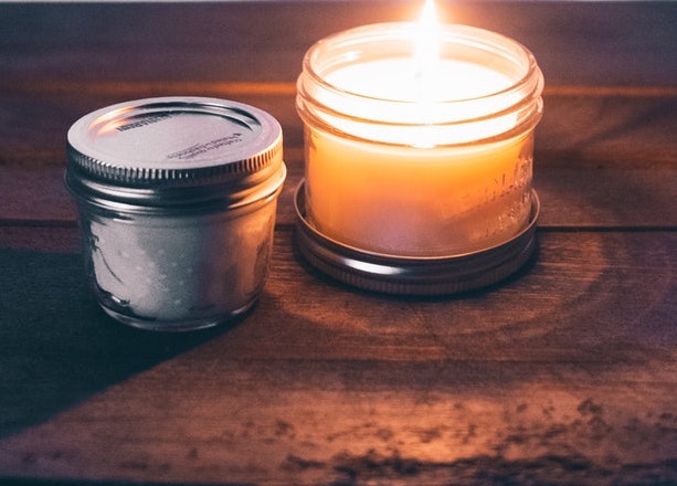 Two candles on a wooden table. 