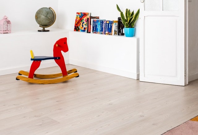 A bright red toy, a bright area rug in a child's room