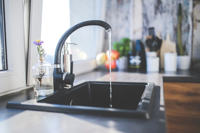 A kitchen faucet running water