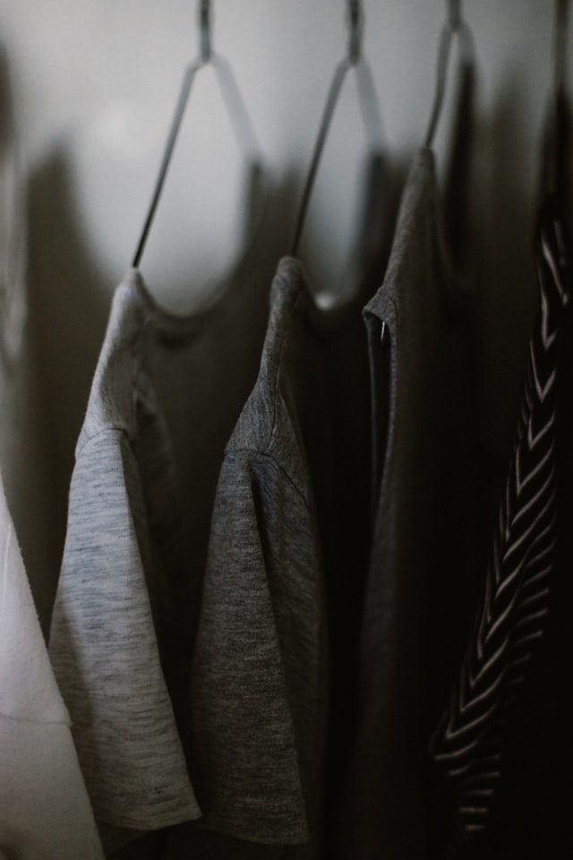 Three t-shirts on hangers.