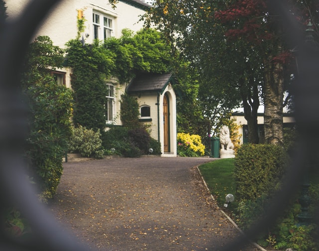 A view of a curb through a grill outside the home