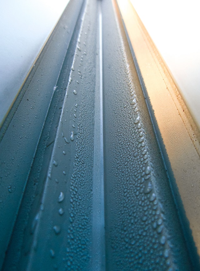 A close up of gutters with water condensation 